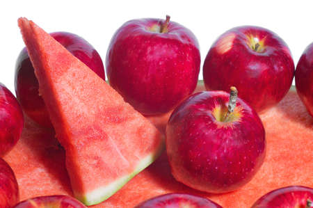 Ripe rustic red autumn apples on the background of watermelon. Fruit harvest in nature in fall season orchardの写真素材