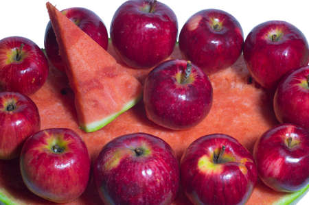 Ripe rustic red autumn apples on the background of watermelon. Fruit harvest in nature in fall season orchardの写真素材
