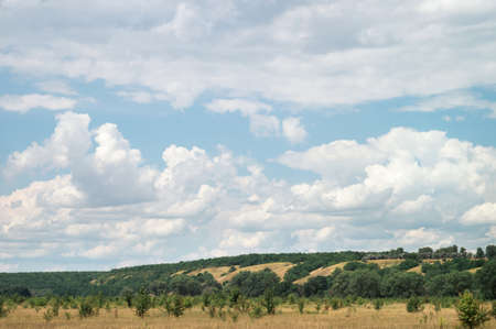 A cloudy day in a green summer hilly valley.の写真素材