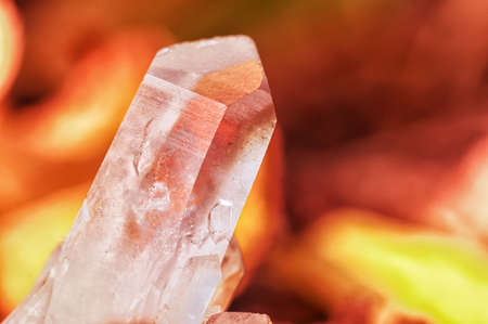 Quartz crystal on background of bonfire coals and burning fire orange color . Beautiful gem chalcedony.の写真素材