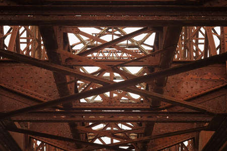 Old iron rusted reinforcement armature structure of a railway bridge with rivetsの写真素材