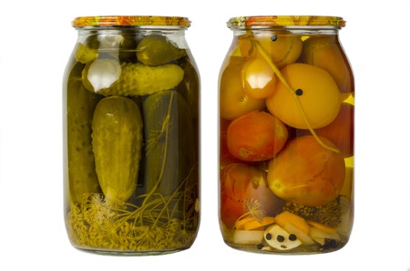 Salted cucumbers and tomatoes in homemade salted cans on white backgroundの写真素材