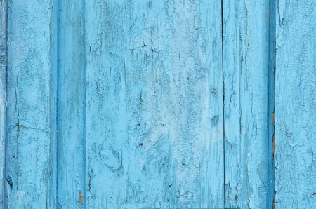 Old cracked painted wooden door and shabby about timeの写真素材