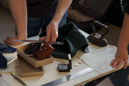 A guy and a girl discuss leather design in a leather workshopのeditorial素材