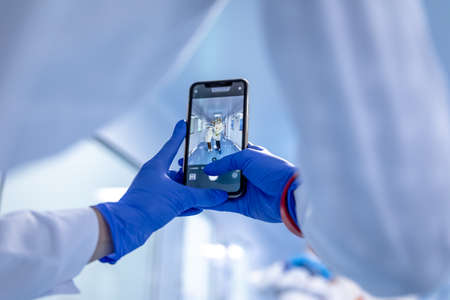 Young employees of the pharmaceutical laboratory are photographed in the corridor of the pill factoryの写真素材