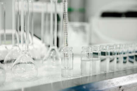 Empty clear glass medicine bottles. Medical manufacturing backgroundの写真素材