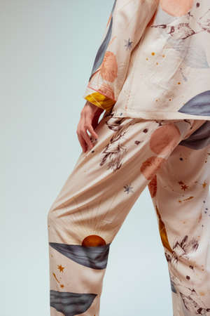 Beautiful booty of a young woman in fashionable beige pajamasの写真素材