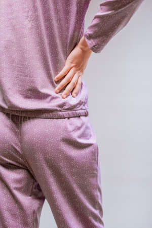 Beautiful sexy woman wearing a pink pajama. Fashion model on a beige background.の写真素材