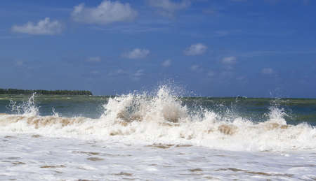 Ocean wave breaking near caribbean shoreの写真素材
