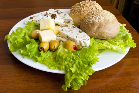 Light mediterranean lunch with chesse, bread and olives