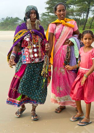 GOA, INDIA - SEPTEMBER 18, 2011: Indian women in traditional dress propose theirs handmade   jewellery on the Goa beach, SEPTEMBER 18, 2011のeditorial素材