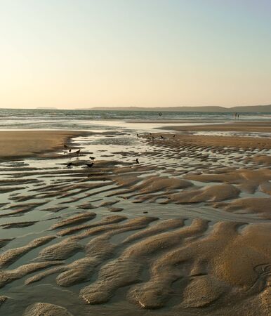 Ocean ebb(tide) at sunset in South Goa. Indiaの写真素材