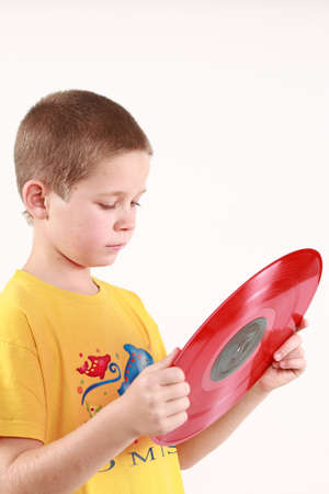 Young boy is holding the LP and reading the namesの写真素材