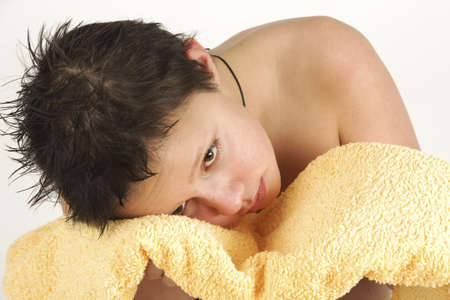 Boy with yellow towel after taking bathの写真素材