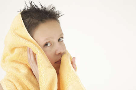 Boy with yellow towel after taking bathの写真素材