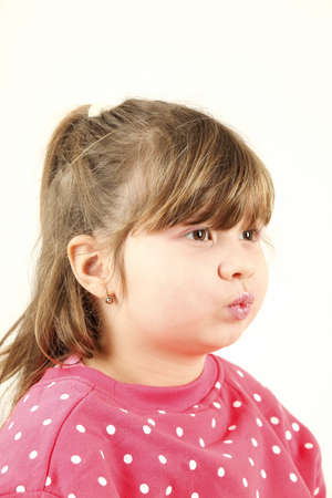 Six years old girl sends kiss isolated on white background