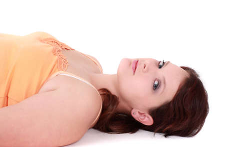 Portrait of teenage girl lying down, studio shotの写真素材