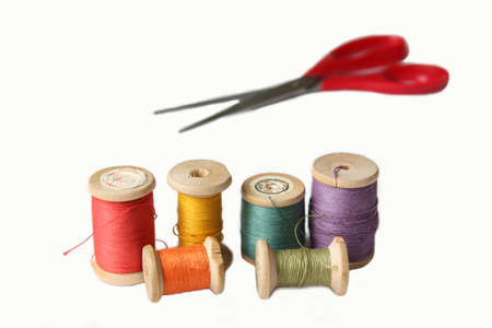 Accessories for sewing. Threads in many colors and scissors. Isolated on whiteの写真素材