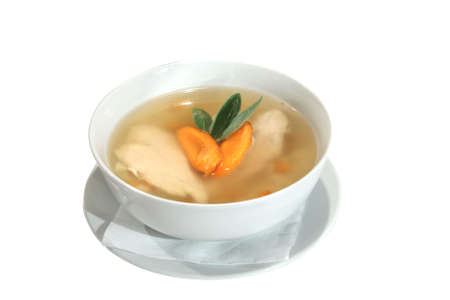 chicken soup with carrots and sage in bowl. Isolated on whiteの写真素材
