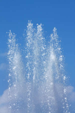 Water jet in a fountain in a bright sunny dayの写真素材