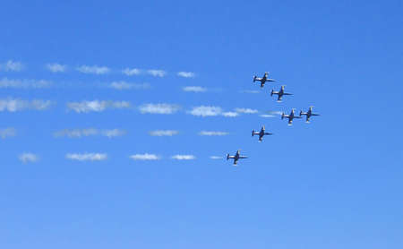 Fighter squadron formation leaving smoke trails