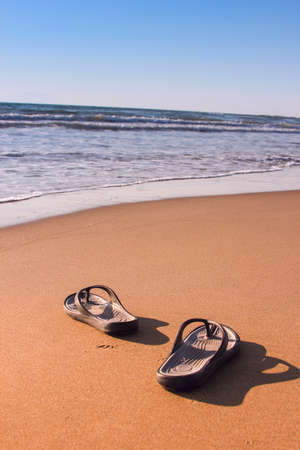 Flipflops on a sandy beach  Summer vacation concept の写真素材