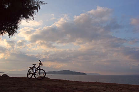 Silhouette of a mountain bicycle at the seashore  Twilight before the sunriseの写真素材