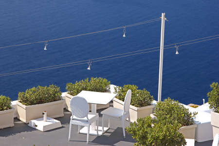 A cozy terrace with chairs and a table  View to the sea, Santorini, Greeceの写真素材
