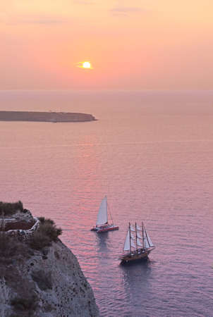 Two sailing ships at sunsetの写真素材