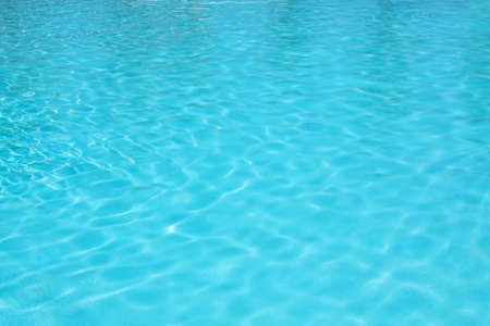 Rippling water in a pool. Bright blue water backgroundの写真素材
