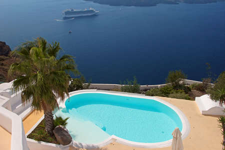 Swimming pool of a hotel with the view over caldera. Santorini, Greeceの写真素材