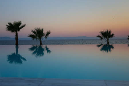 Sunset over an infinity poolの写真素材