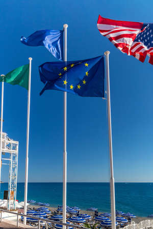 European and American flags on the background of the sky and the seaの写真素材