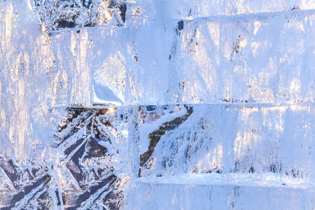 Full frame ice background. Backlit with the sunの写真素材