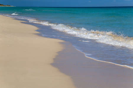 Blue wave on a white sand tropical beachの写真素材
