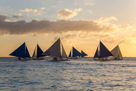 Small sailing boats at the sunset. Boracay, Philippinesの写真素材
