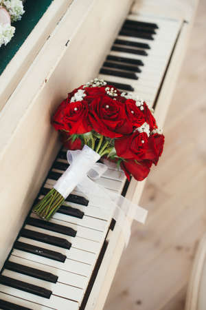 The bridal bouquet from roses lies on piano keysの写真素材
