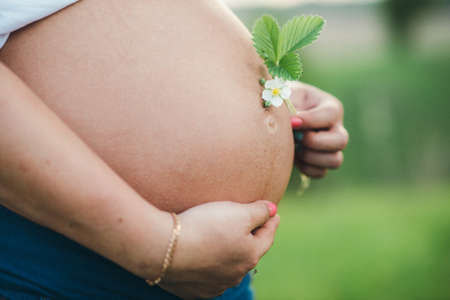 pregnant woman with painted husband on white paints watercolor brush wordの写真素材