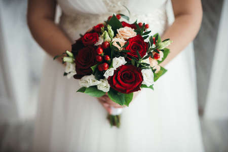Bridal bouquet of red roses isolated on whiteの写真素材