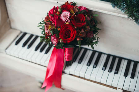 Bridal bouquet of red roses isolated on whiteの写真素材