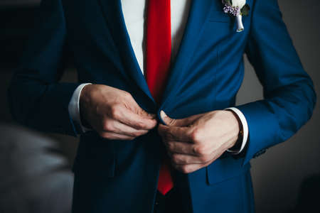 the groom in a blue suit and maroon butterflyの写真素材