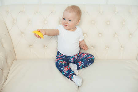 a little girl for the first time trying a lemonの写真素材