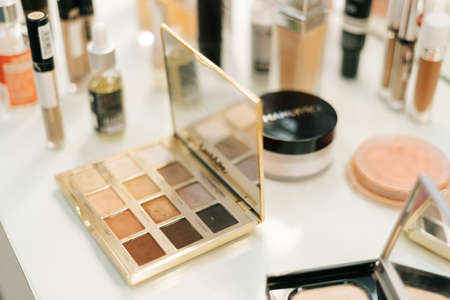 Close-up of professional powder box on woman table near mirror, nobody, top view. Concept of beauty,...