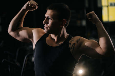 Handsome muscular man with perfect beautiful body wearing sportswear standing in pose Champion in...