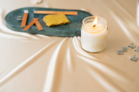 Close-up shot of components for production of aromatic eco handmade candles on light background. Closeup composition with ingredients for scented home-made candles.の写真素材