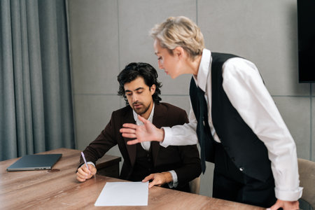 Female angry boss reprimands incompetent male employee for bad work result, decreasing financial...