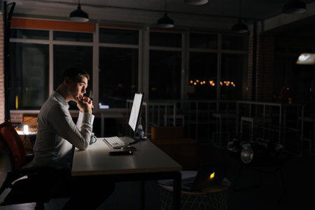 Pensive male trader working at desktop computer, thinking analyzing online trading market finance...