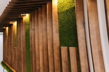 Wooden panels creating dynamic and visually appealing pattern alongside vibrant green wall,...