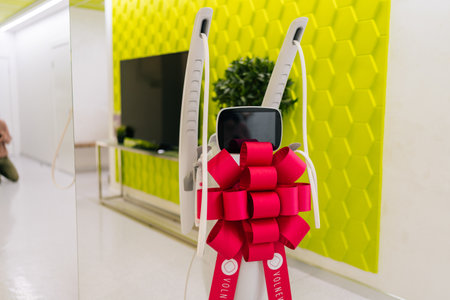 Mesotherapy apparatus with festive bow in corridor of new beauty clinic or medical center, symbolizing innovation in skincare, aesthetic medicine, nobody. Concept of anti-age rejuvenation skincare.の写真素材