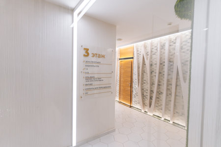 Modern minimalist interior of beauty clinic corridor showing floor plan with directions to different treatment rooms, spa, fitness area and restrooms, no people, nobody.の写真素材